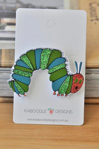 Glitter caterpillar brooch on Kaboodle Designs backing card, front view showing green and blue segments and red face