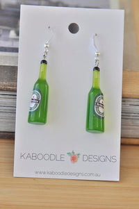 Pair of green resin Heineken beer bottle drop earrings on Kaboodle Designs card