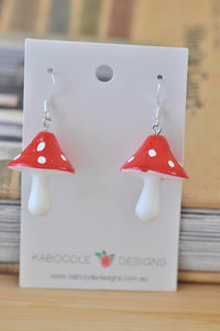 Red and white polka dot mushroom resin drop earrings displayed on Kaboodle Designs card