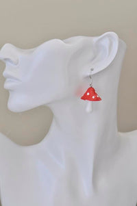 Single mushroom drop earring worn on ear, shown on white display mannequin
