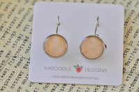 Round peach dangle earrings with silver-plated posts on a Kaboodle Designs card
