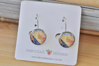 Round dangle earrings with yellow, purple and blue zebra stripe pattern on card backing