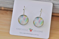 Round watercolour dangle earrings in pastel pink, lilac and blue on Kaboodle Designs card
