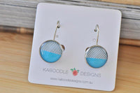 Round dangle earrings on card, split design in grey stripes and solid blue with silver-tone hooks