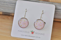 Round pink watercolour dangle earrings with gold foil flecks on Kaboodle Designs card
