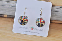Round geometric pattern dangle earrings in red, navy and mustard on Kaboodle Designs card