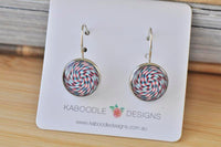 Round swirl artwork dangle earrings in red, white and blue on Kaboodle Designs card