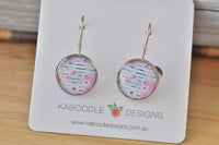 Round boho floral dangle earrings on Kaboodle Designs display card, front view