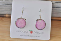Round pink and lilac watercolour dangle earrings on Kaboodle Designs card, front view