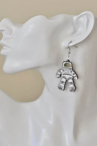 Single astronaut earring with mirrored visor worn on a model ear, side view