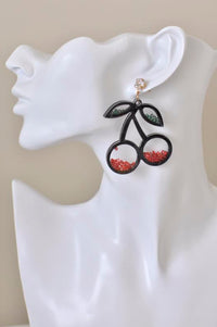 Cherry drop earring worn on ear, showing crystal stud and beaded cherry design