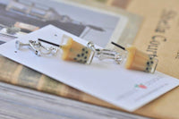 Pair of bubble tea clip-on earrings laid flat showing silver clip fittings