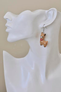 Single tan-toned llama earring shown worn on ear for scale