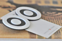 Pair of black and white target circle earrings lying on a Kaboodle Designs card