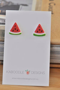 Red and green clay watermelon slice stud earrings on Kaboodle Designs card