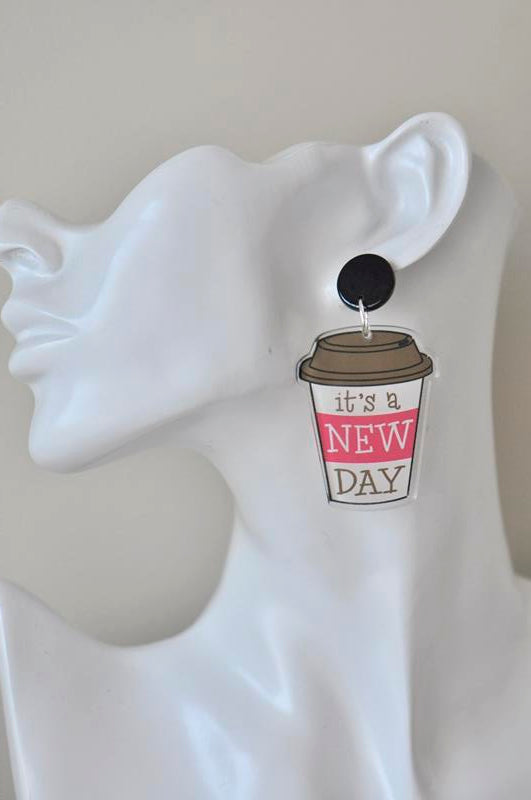 Coffee cup dangle earring worn on a white display ear model showing the stud and drop