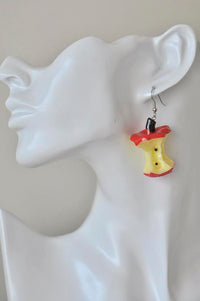Apple core drop earring shown worn on a model's ear, close-up side view