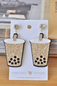 Gold glitter bubble tea cup earrings on Kaboodle Designs card with crystal stud tops