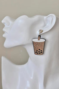 Single glitter boba cup earring shown on model's ear for scale