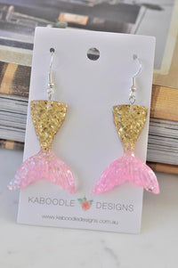 Gold and pink glitter resin mermaid tail drop earrings on Kaboodle Designs card