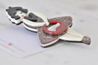 Underside of retro lady brooch showing hinge clasp pin fastening