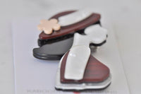 Angled view of the retro lady brooch showing the hinge clasp pin on the back