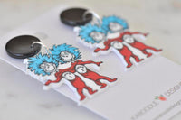 Close-up angled view of Thing 1 and Thing 2 earrings showing print detail and black studs