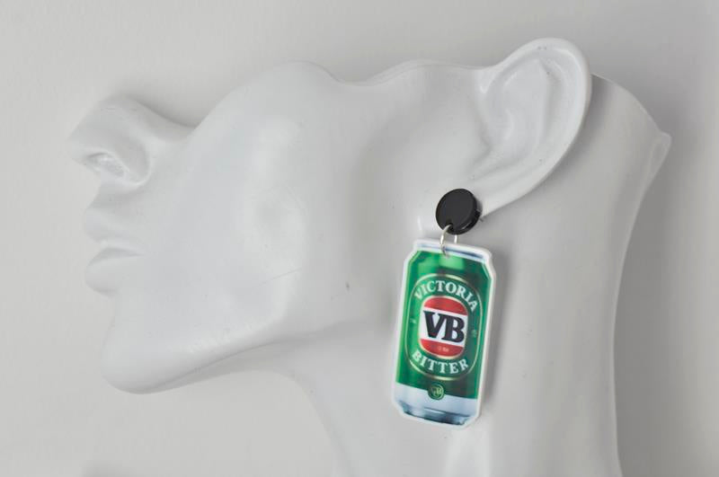 VB beer can earring worn on a mannequin ear showing the dangle drop style
