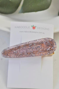 Purple glitter barrette clip laid flat on a Kaboodle Designs backing card