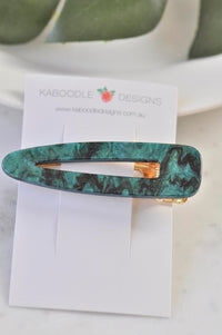 Emerald green barrette clip displayed on Kaboodle Designs branded card