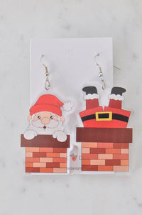 Acrylic Santa Claus chimney drop earrings on card, one showing Santa's face and one his legs