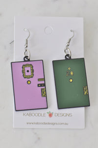 Lilac and green enamel door earrings on a Kaboodle Designs card, front view