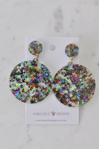 Rainbow glitter star resin circle drop earrings on Kaboodle Designs card