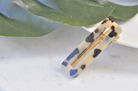 Rectangular leopard print acrylic barrette clip shown open at an angle