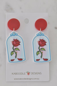 Pair of red rose glass dome drop earrings on Kaboodle Designs card, front view