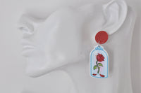 Close-up of one rose dome earring worn on a display ear model