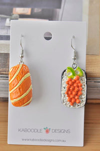 Ceramic sushi earrings on card, salmon sashimi drop and roe nigiri drop with cucumber