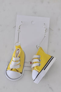 Pair of yellow fabric sneaker drop earrings with white laces on Kaboodle card