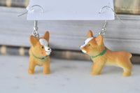 Close-up of corgi earrings showing painted white blaze and green collar