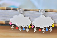 Front view of both cloud dangle earrings side by side showing full rainbow raindrop and lightning detail