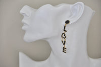 Single LOVE letter earring worn on ear showing full drop length and heart-shaped O