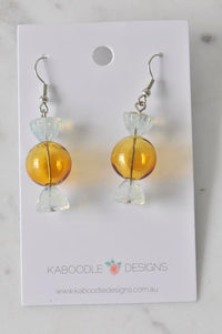 Amber and clear acrylic candy lolly drop earrings on Kaboodle Designs card