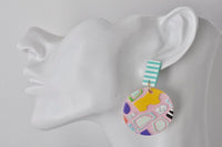 Side profile of model wearing pink geometric round earring with striped stud top