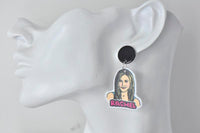 Close-up of Rachel earring on ear showing black stud and illustrated portrait charm