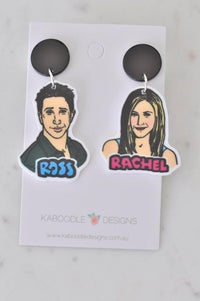 Acrylic Ross and Rachel dangle earrings on card, black stud tops, illustrated portraits with names