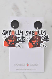 Acrylic Smelly Cat guitar drop earrings on white card with black stud backs
