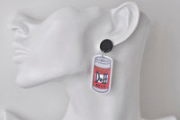 Duff Beer can earring shown on ear model for scale, black stud and dangle