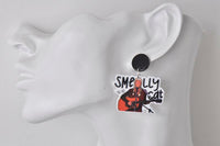 Close-up of Smelly Cat earring worn on ear, showing guitarist design and stud