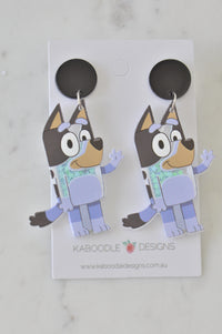 Pair of acrylic blue heeler dog earrings on a Kaboodle Designs card, front view