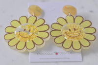 Front view of both sunflower earrings against Kaboodle Designs branded backing card